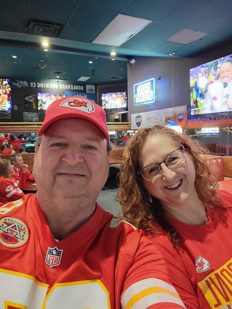 Tammy and her husband Bruce at a Superbowl watch party, getting ready to cheer on their Kansas City Chiefs to a second consecutive Superbowl victory!